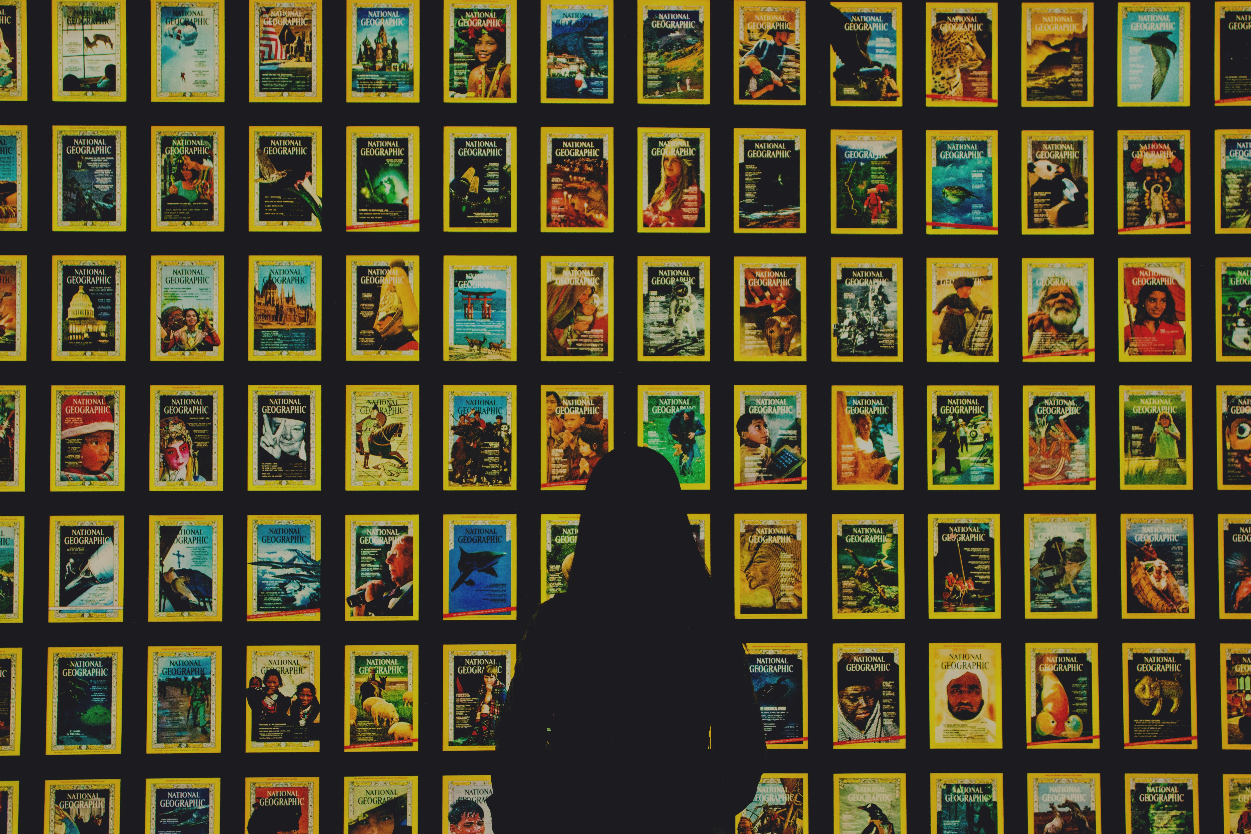 a person standing in front of a wall of movie posters