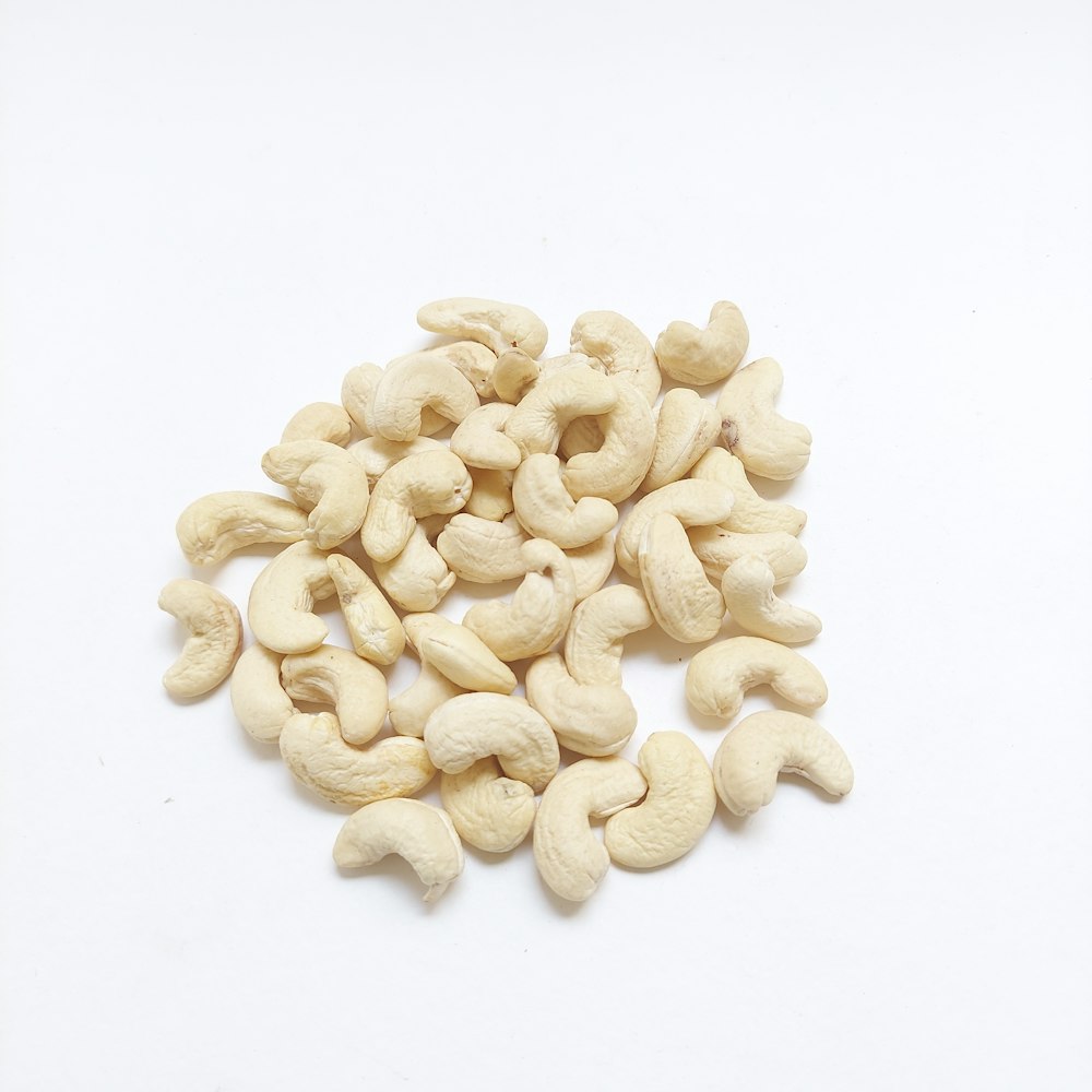 a pile of cashews on a white background