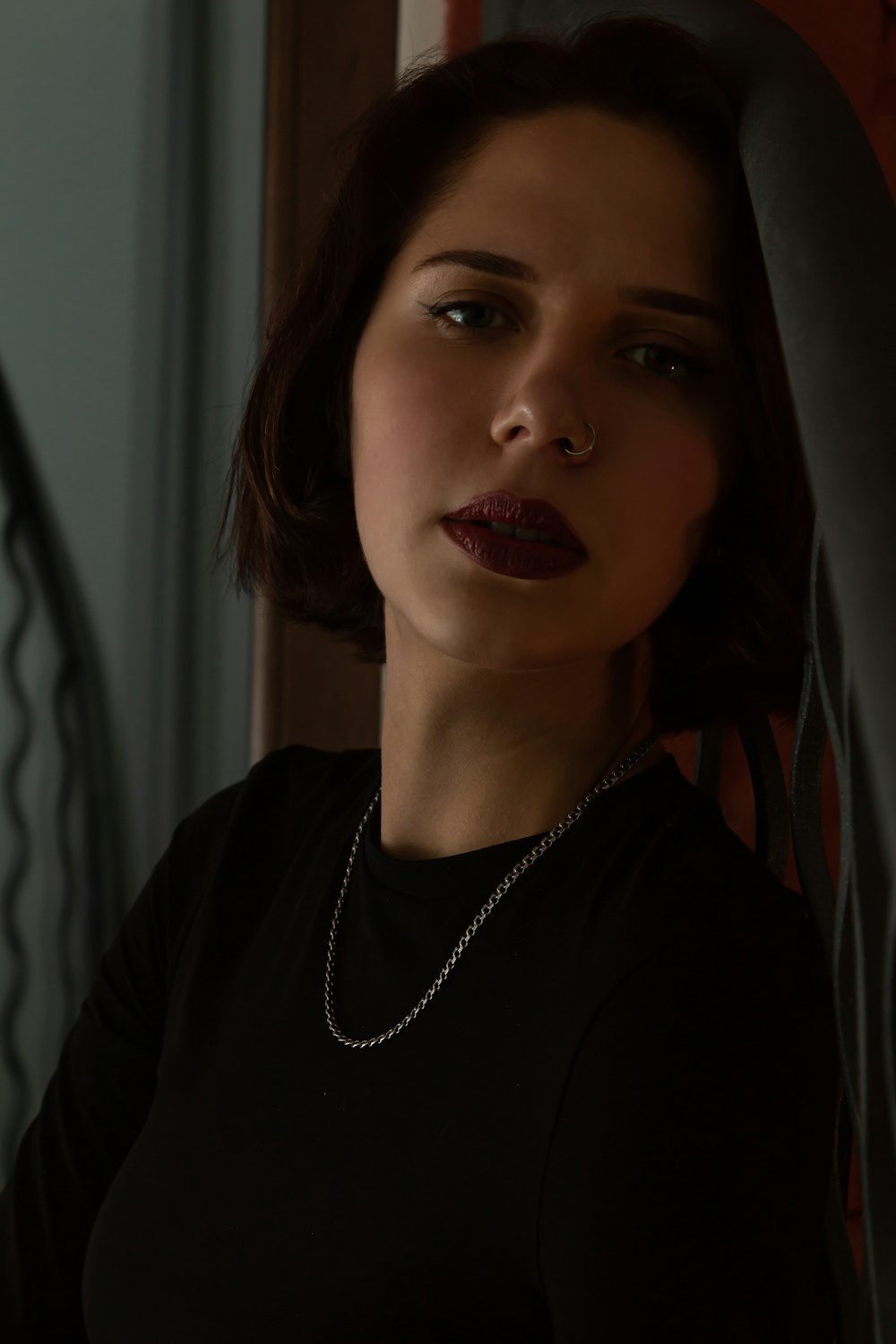 a woman wearing a black shirt and a necklace