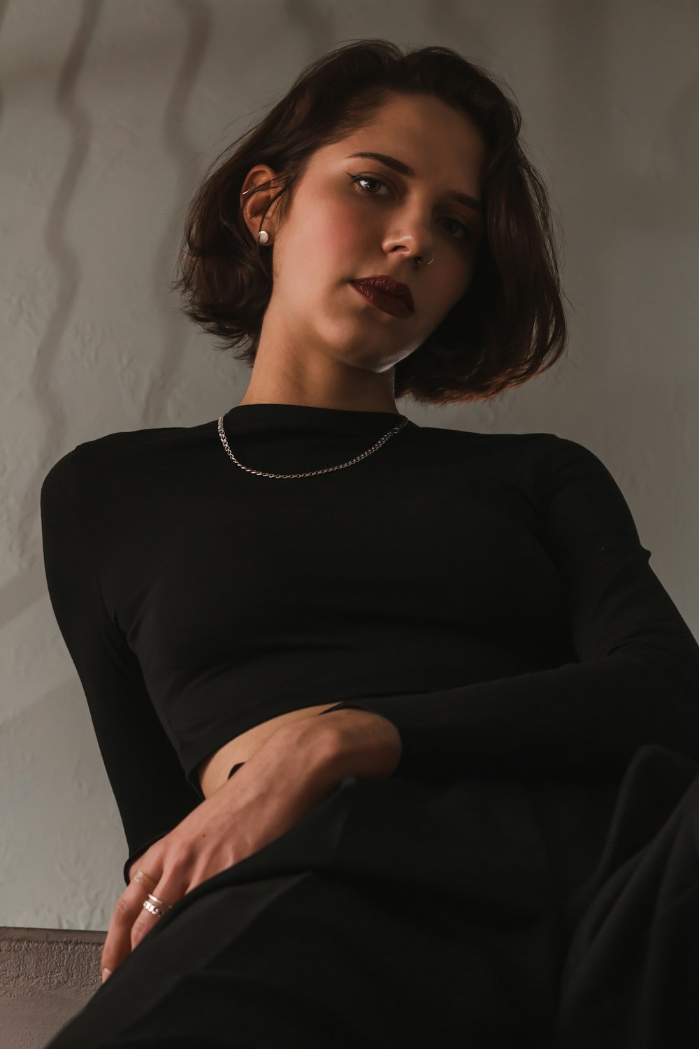 a woman in a black dress sitting down