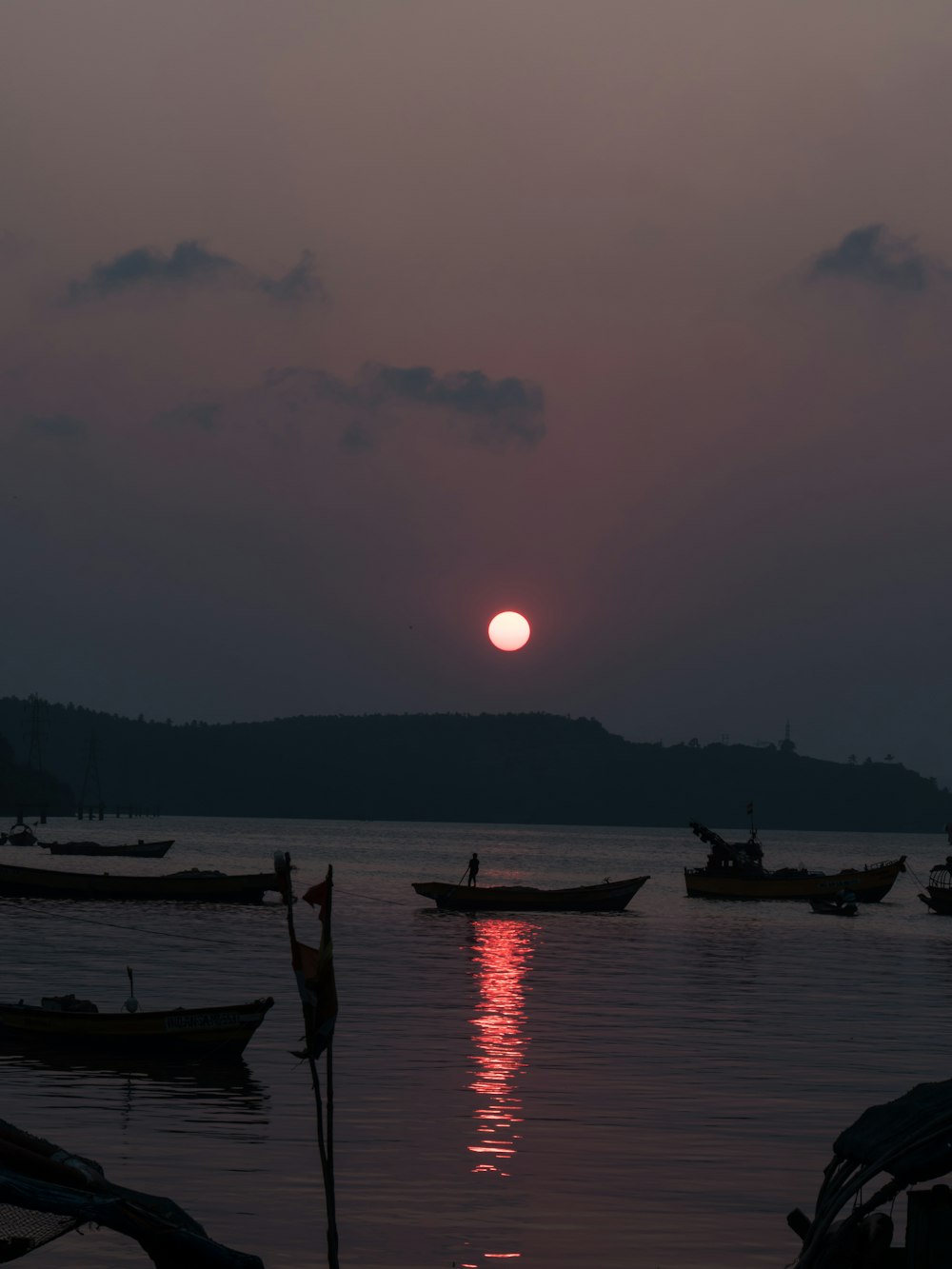 a group of boats floating on top of a body of water