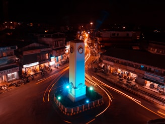a tall clock tower sitting in the middle of a street