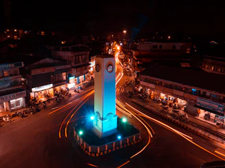 a tall clock tower sitting in the middle of a street
