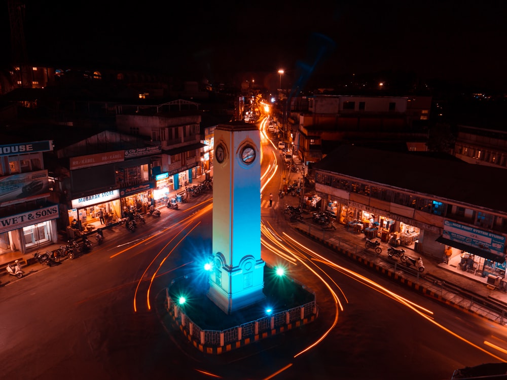a tall clock tower sitting in the middle of a street