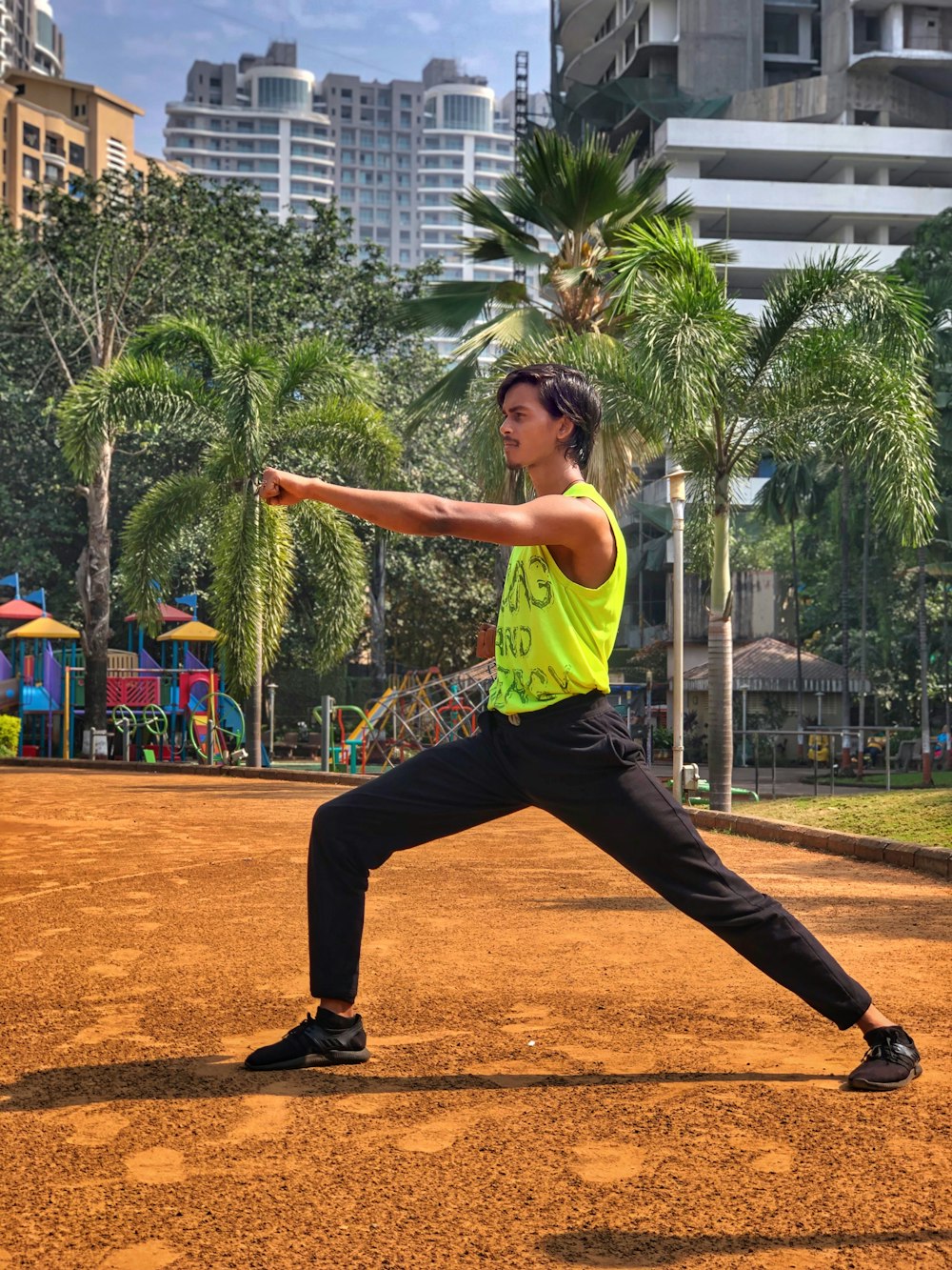 a man in a yellow shirt is playing baseball