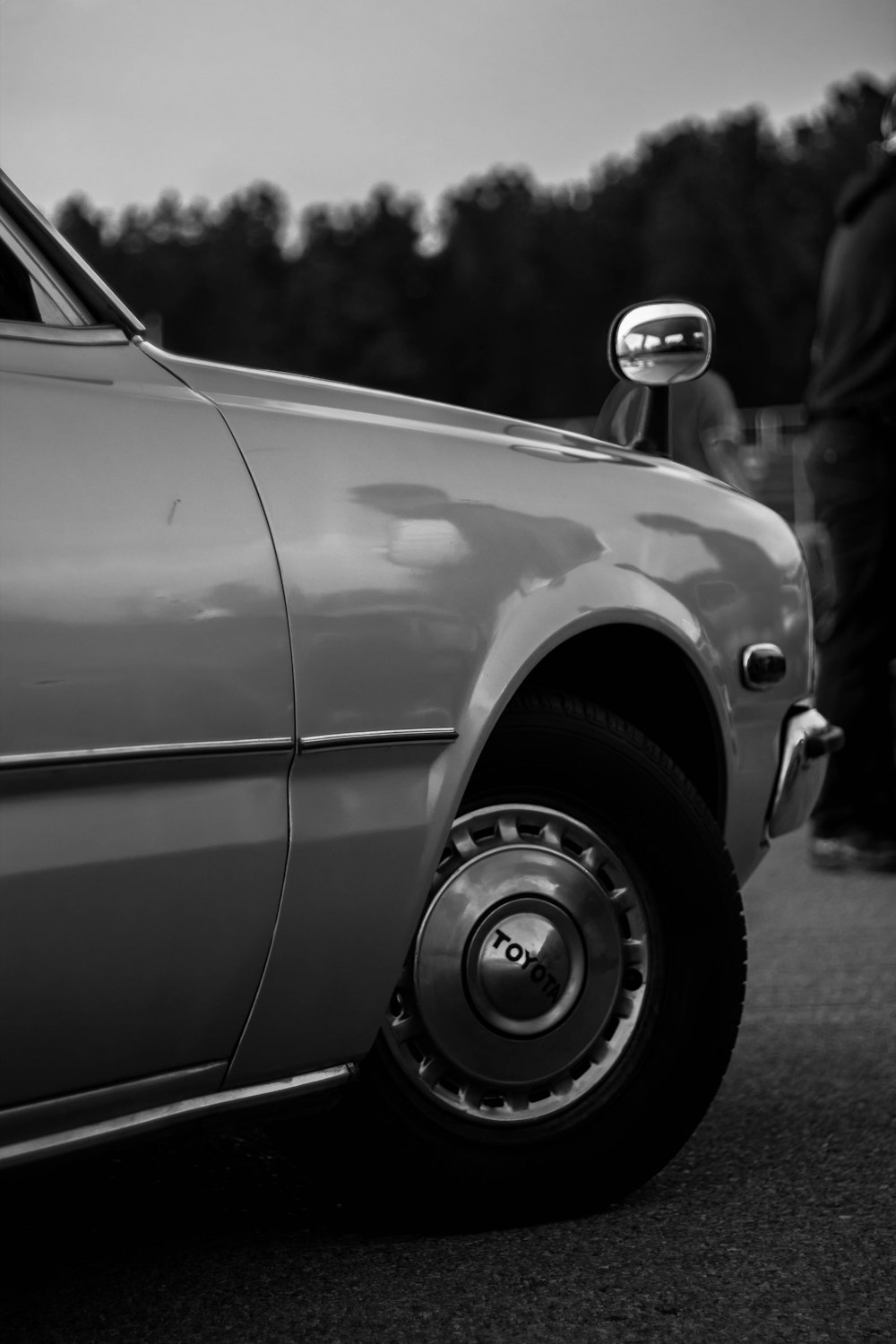 a black and white photo of a parked car