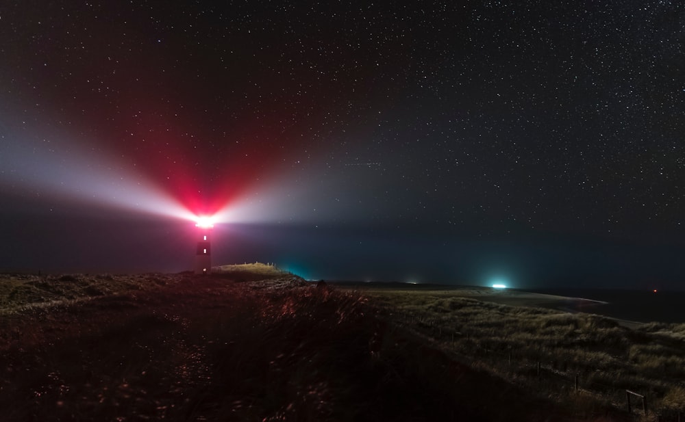 a person standing on a dirt road under a sky filled with stars