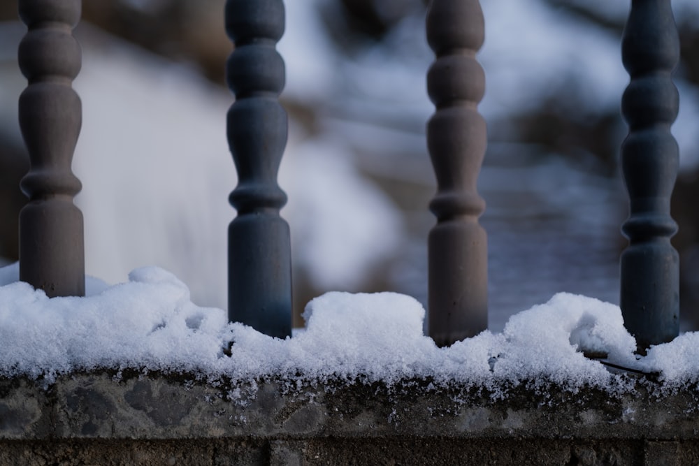 a close up of a fence with snow on it