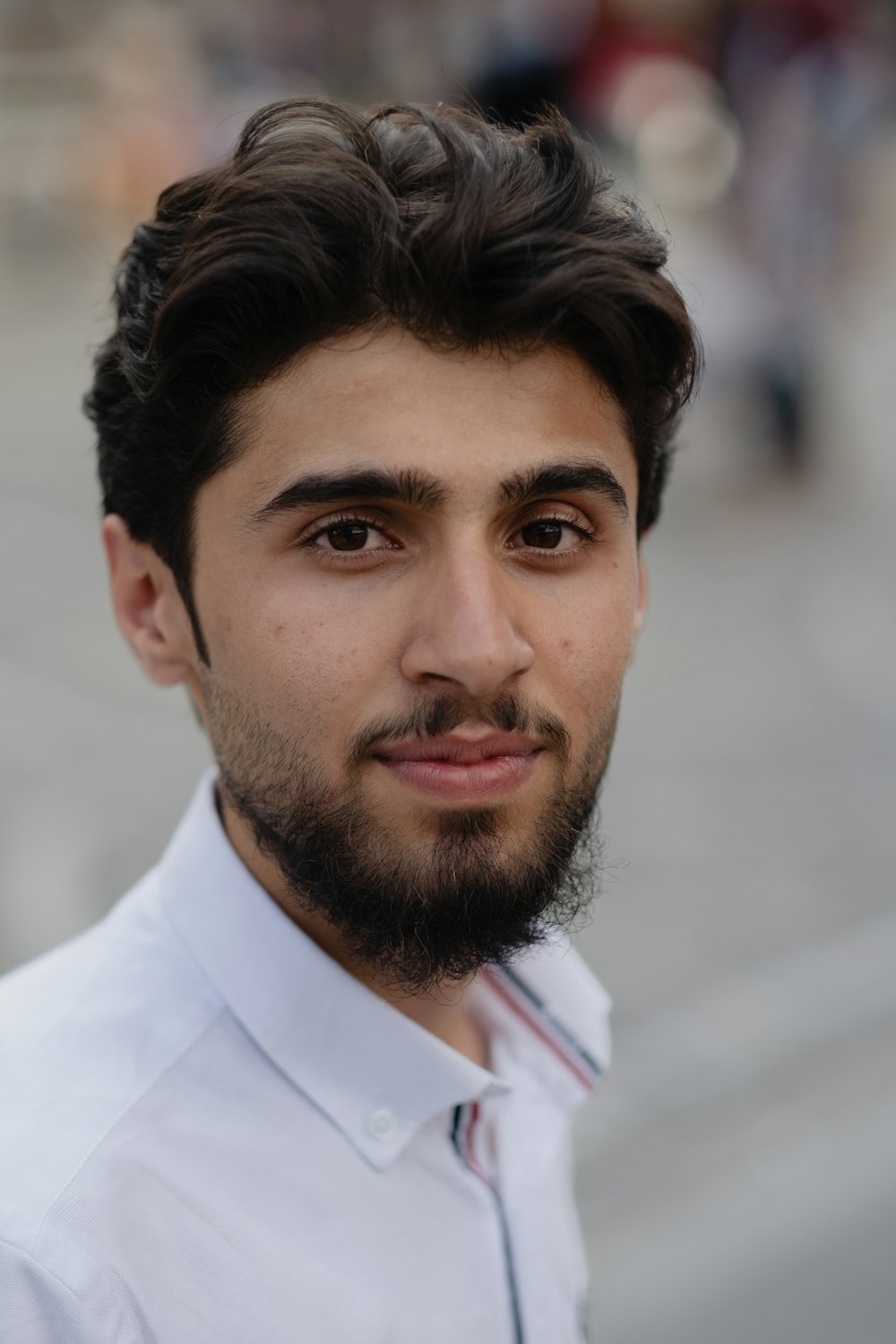 a close up of a person wearing a shirt and tie