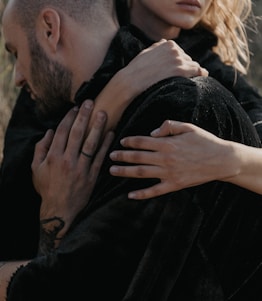 A comforting embrace between two people symbolizing support and presence.