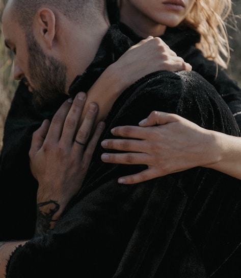 A comforting embrace between two people symbolizing support and presence.