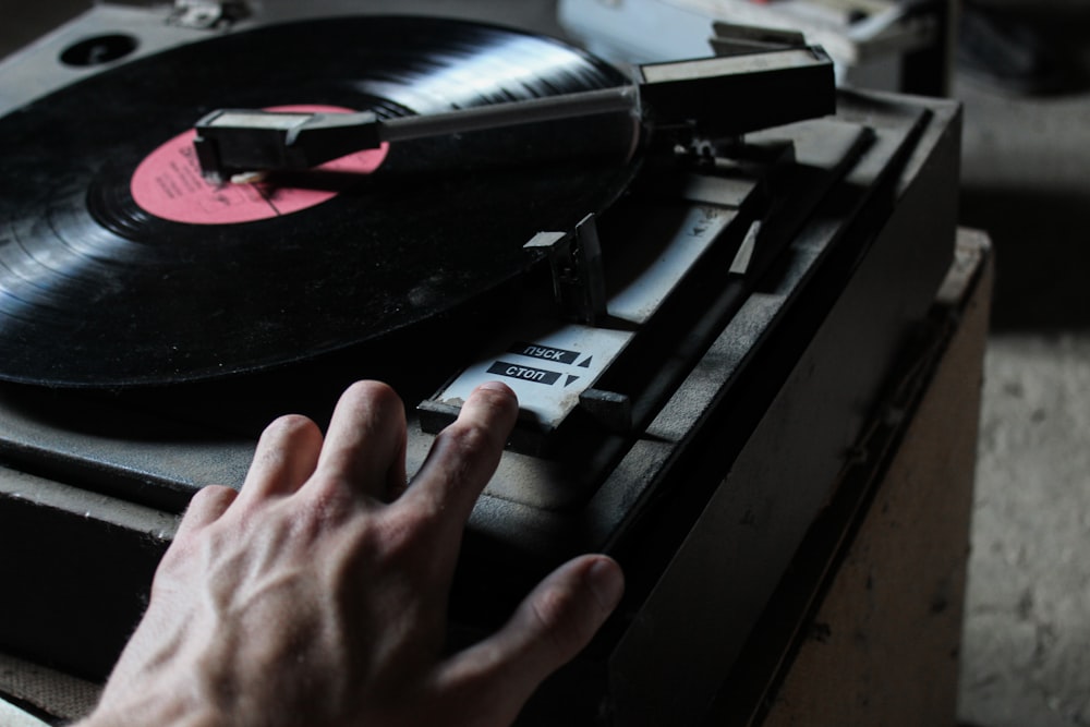 a person touching a record on a turntable