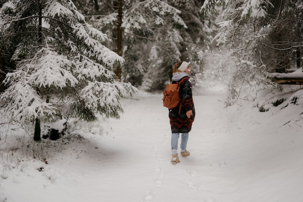 a person walking in the snow with a backpack