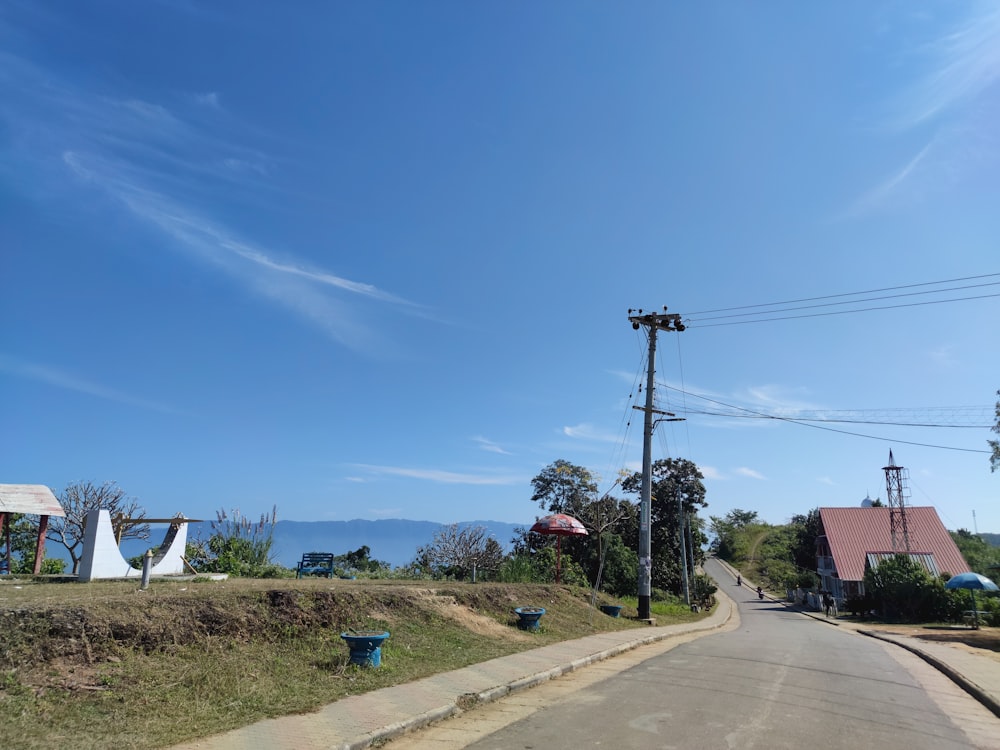 an empty street with a blue sky in the background