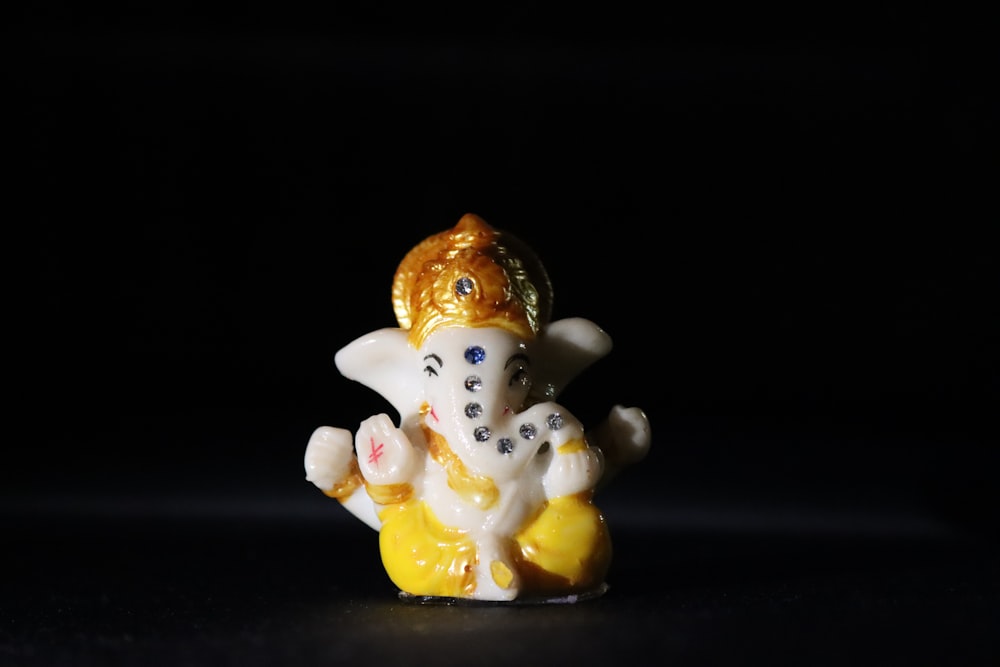 a small figurine of an elephant on a black background