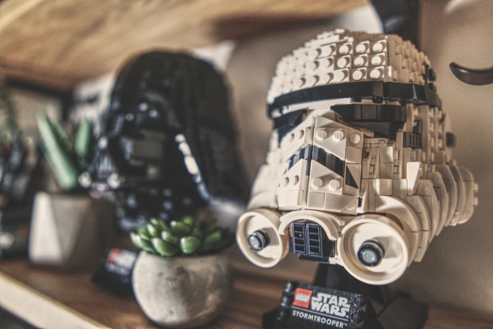 a lego star wars helmet sitting on top of a shelf