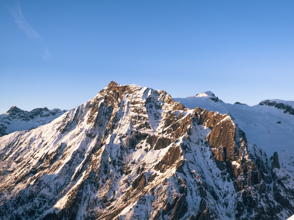 a snow covered mountain with a clear blue sky