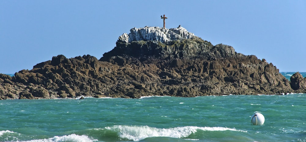 a small island with a cross on top of it