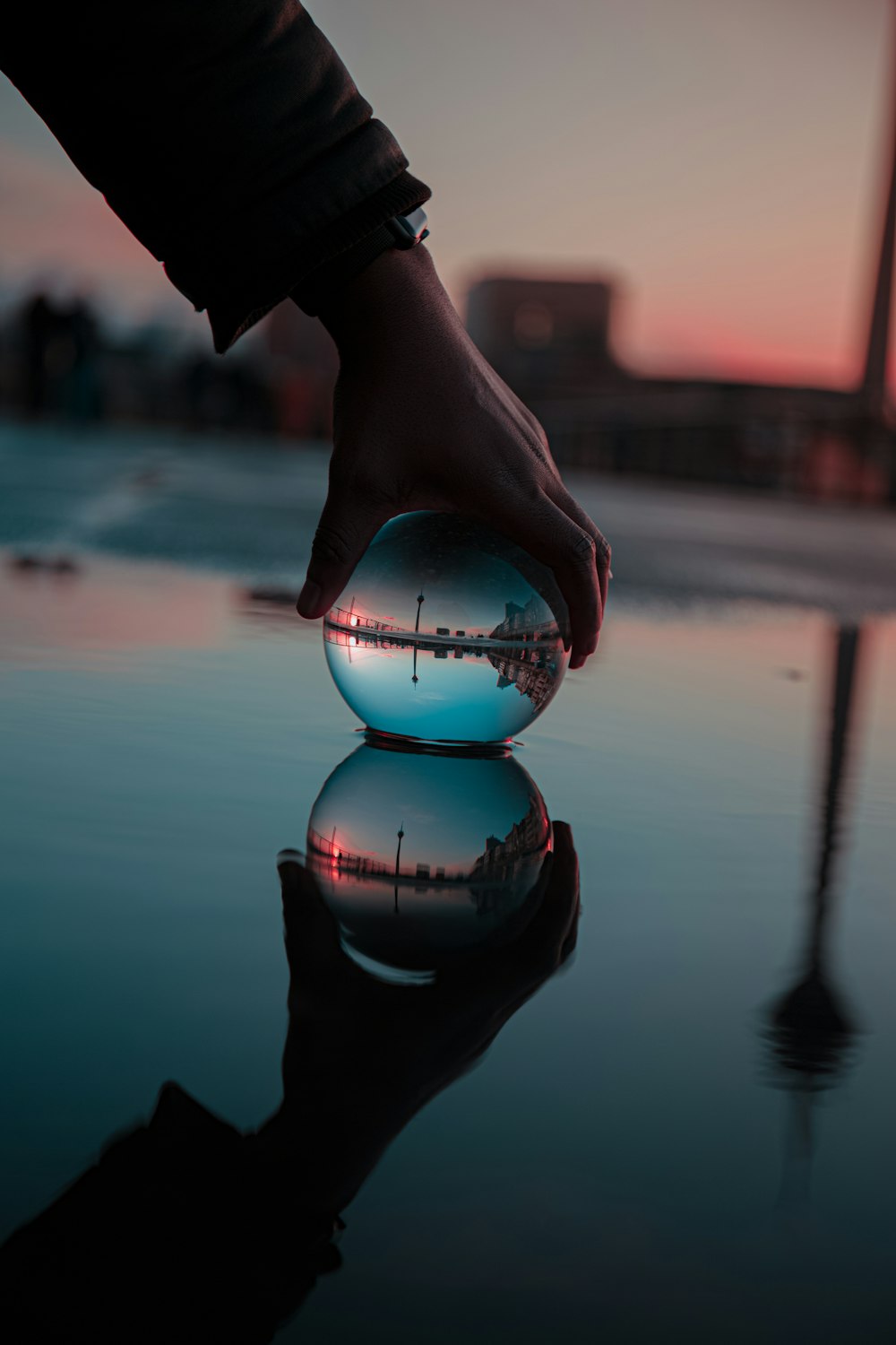 a person holding a glass ball in their hand