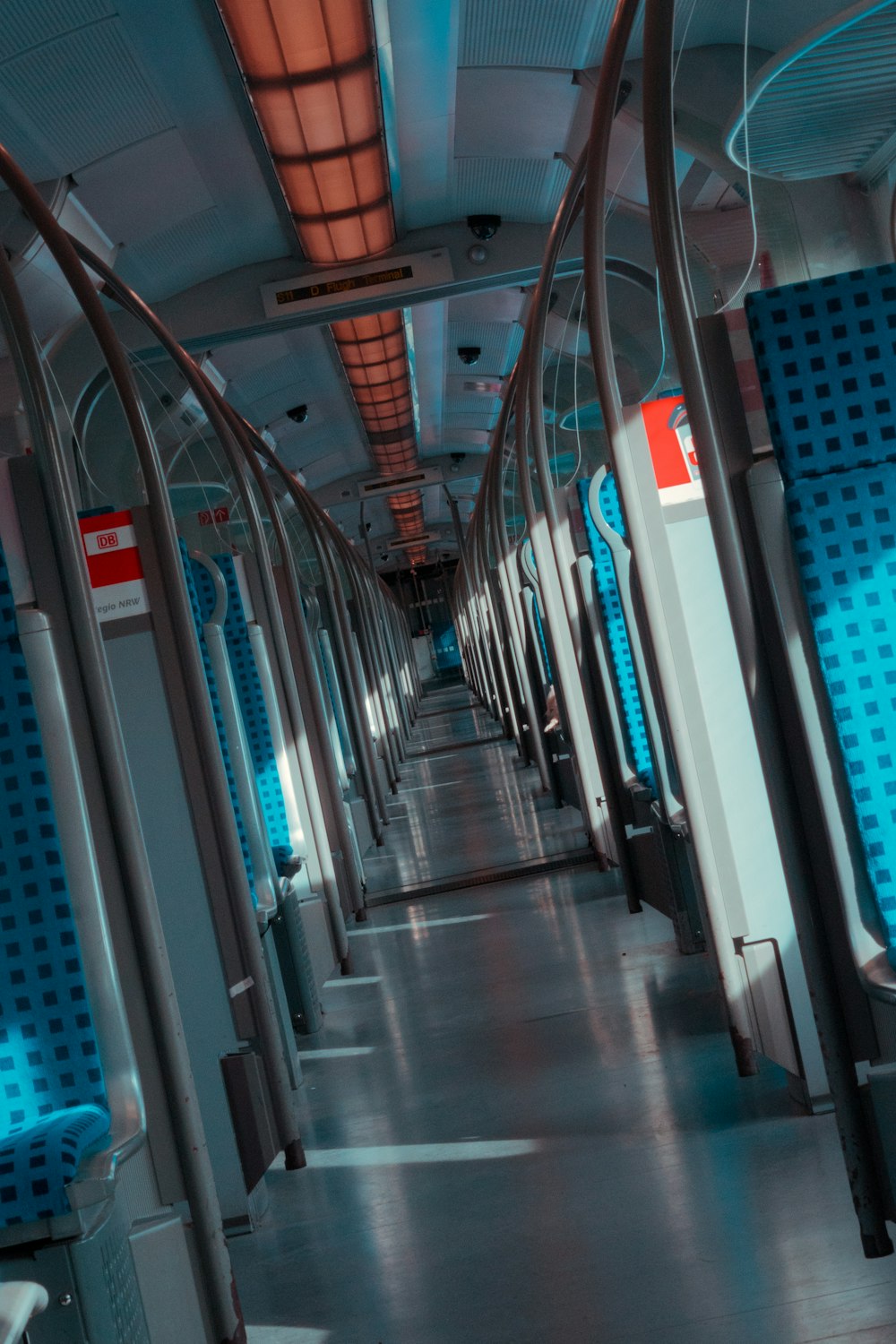 the inside of a train with blue seats