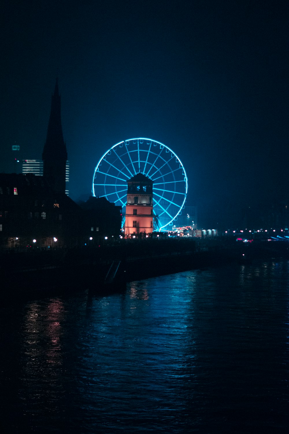 a ferris wheel lit up in the night sky