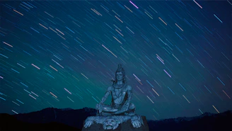A serene figure meditating under a starry sky, with glowing light radiating from the pineal gland area.