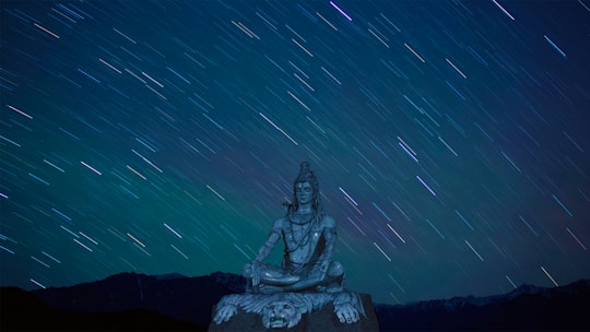 A serene cosmic landscape blending stars and numbers glowing softly around a meditating figure.