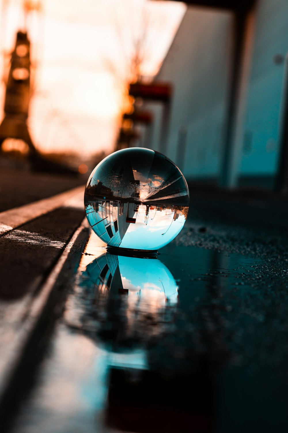 a glass ball sitting on the ground in front of a building