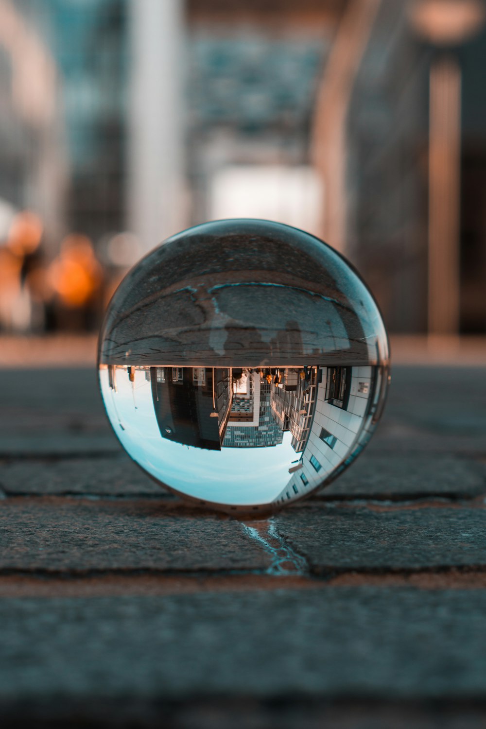 a reflection of a building in a glass ball