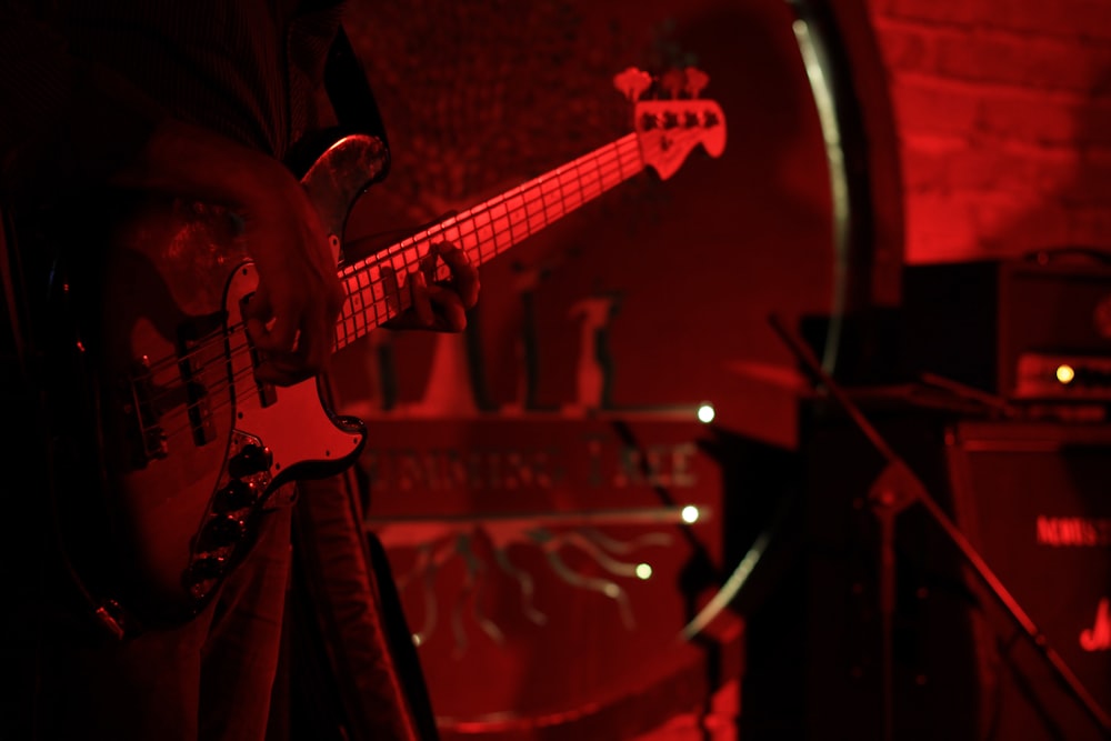 a person playing a guitar in a dark room