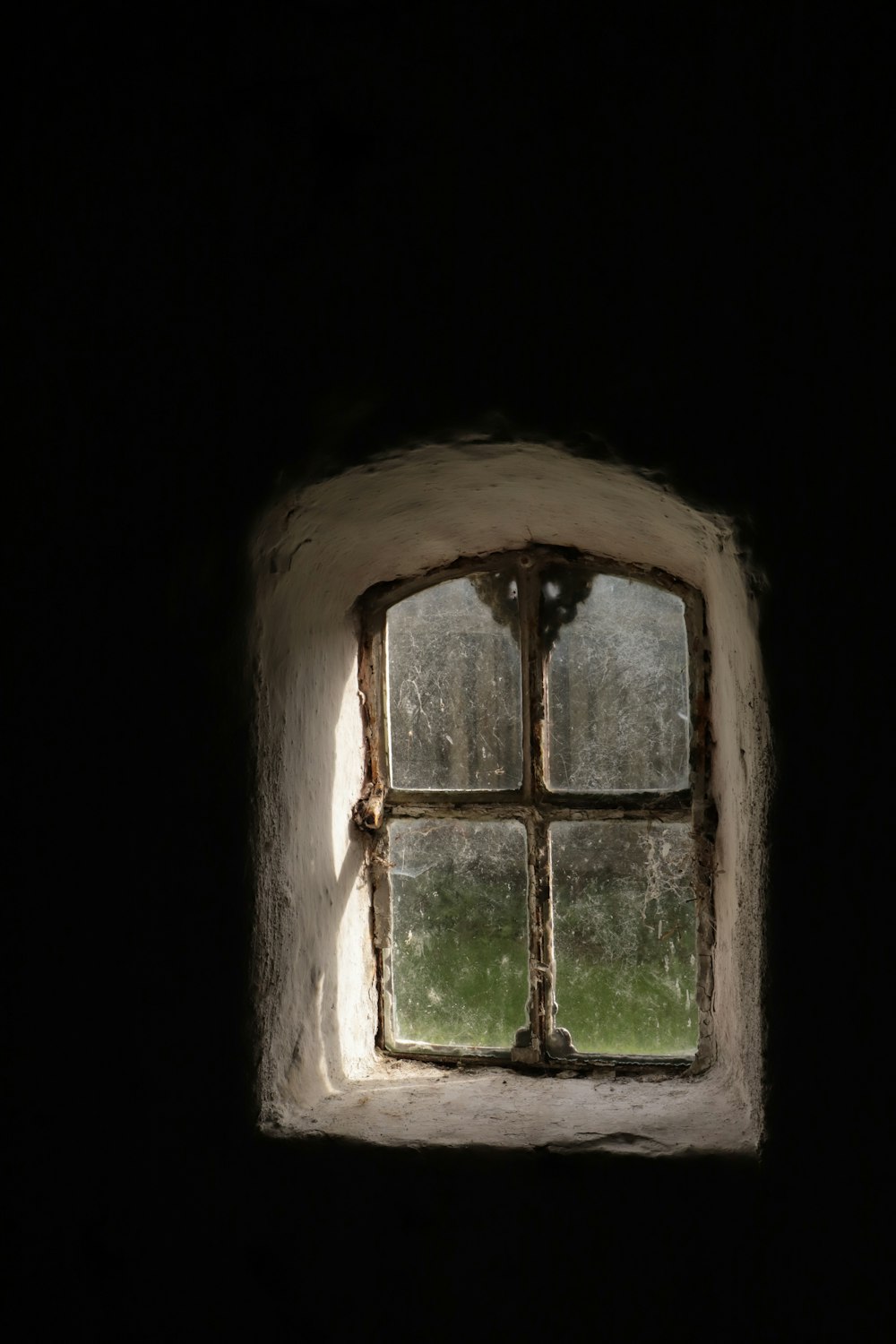 a window with a view of a field through it