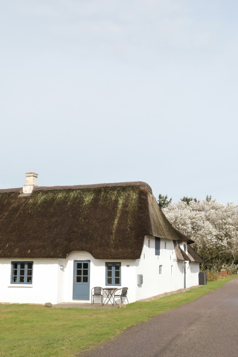 a white house with a thatched roof