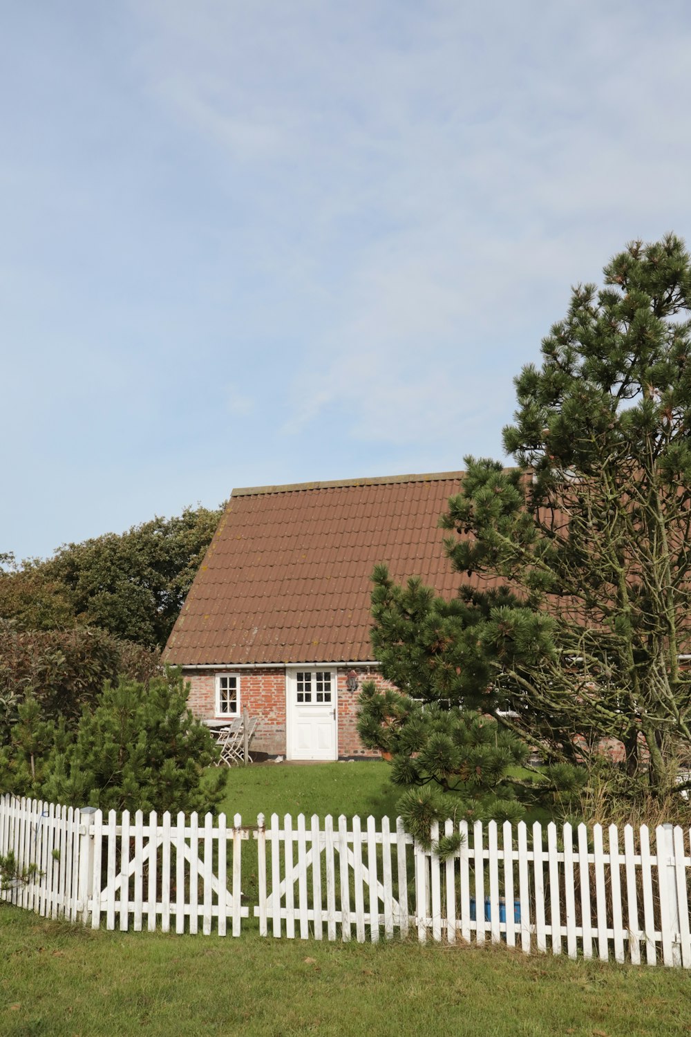 a white picket fence in front of a house