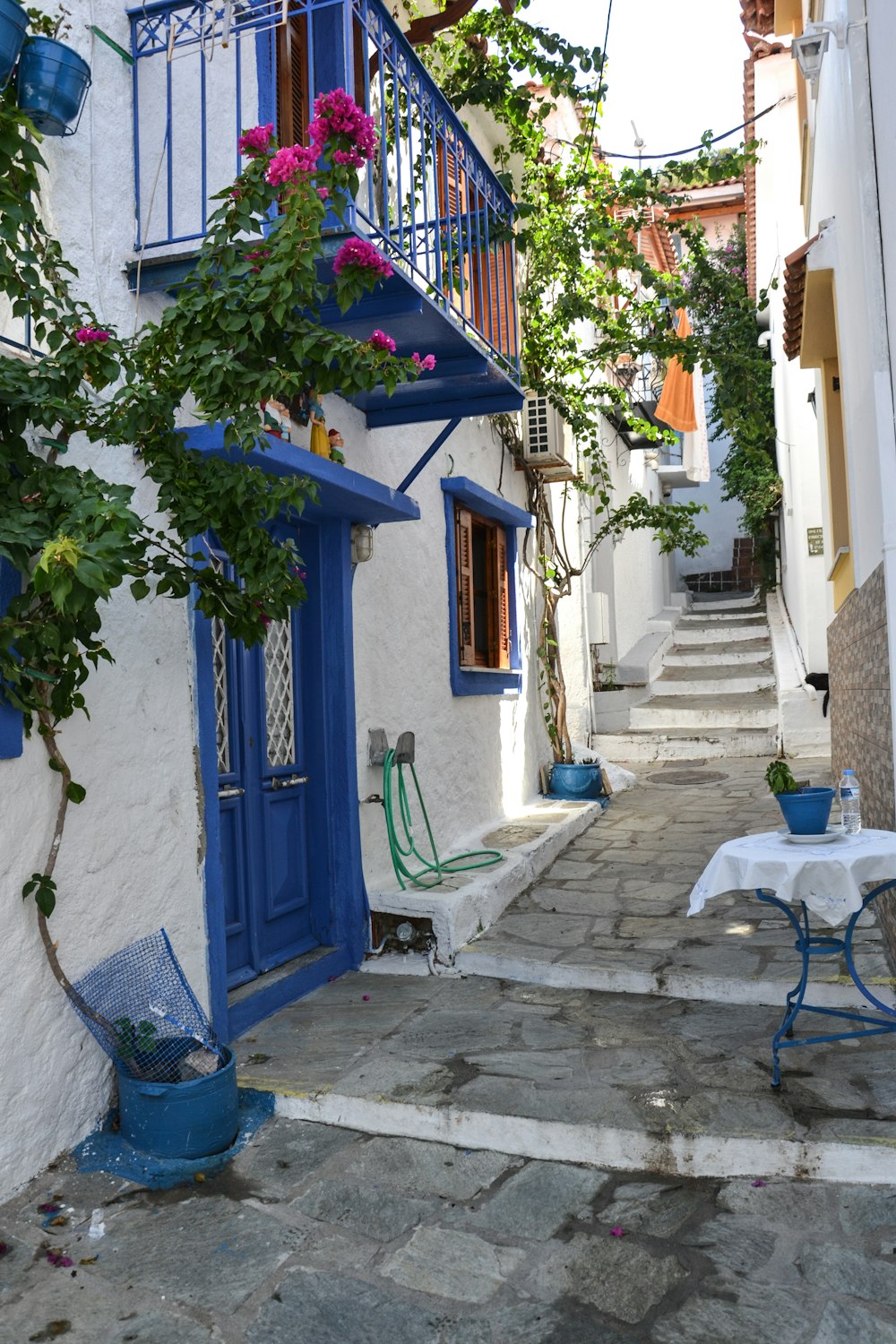 a blue and white building with a table and chairs