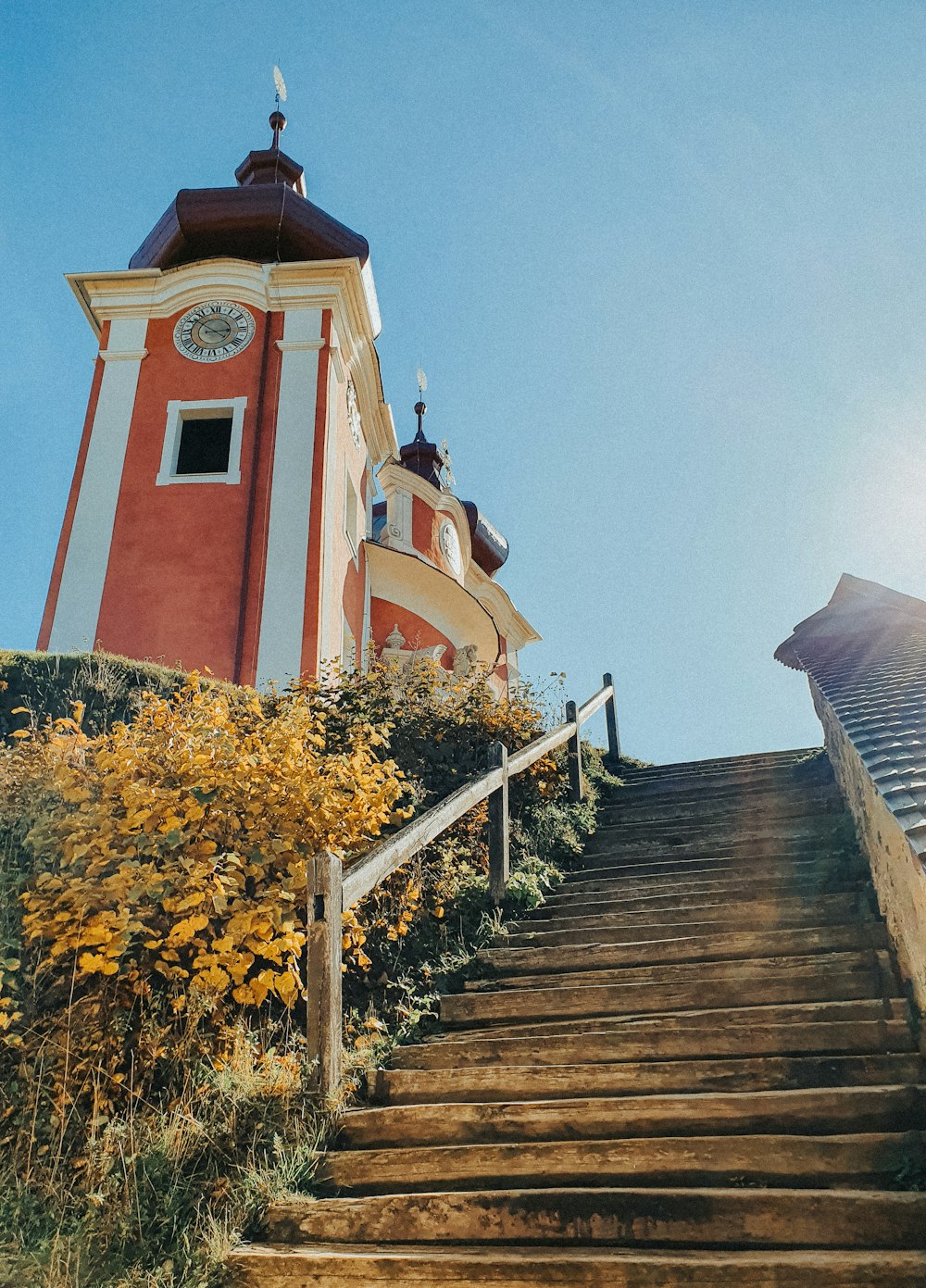 a red and white tower with a clock on top of it