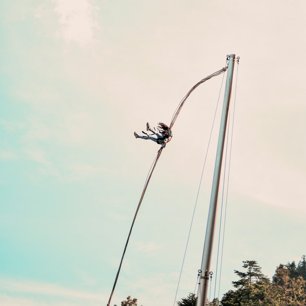 a pole with a person on top of it