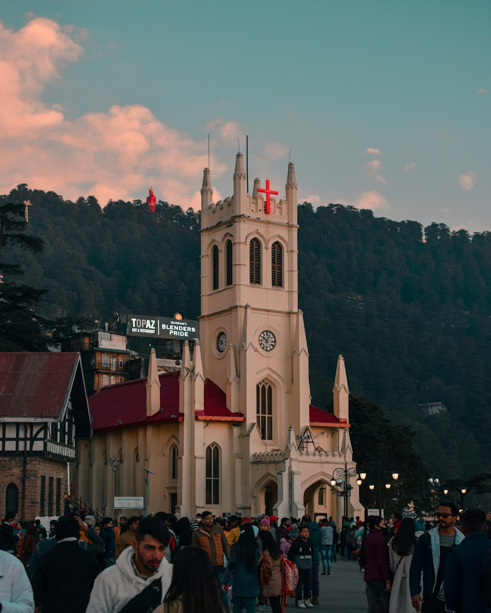 a crowd of people walking around a church