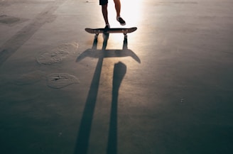 a person riding a skateboard in a parking lot