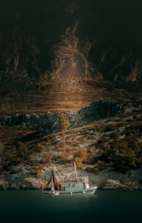 A charming fishing boat anchored near a rocky Atlantic shore at dawn