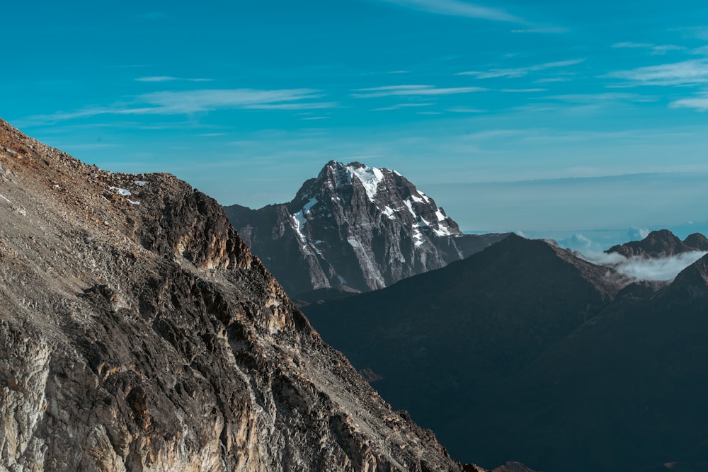 a man riding a snowboard down the side of a mountain