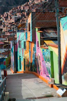 The colorful houses of Comuna 13 climbing the hills, with street art murals and lively staircases.