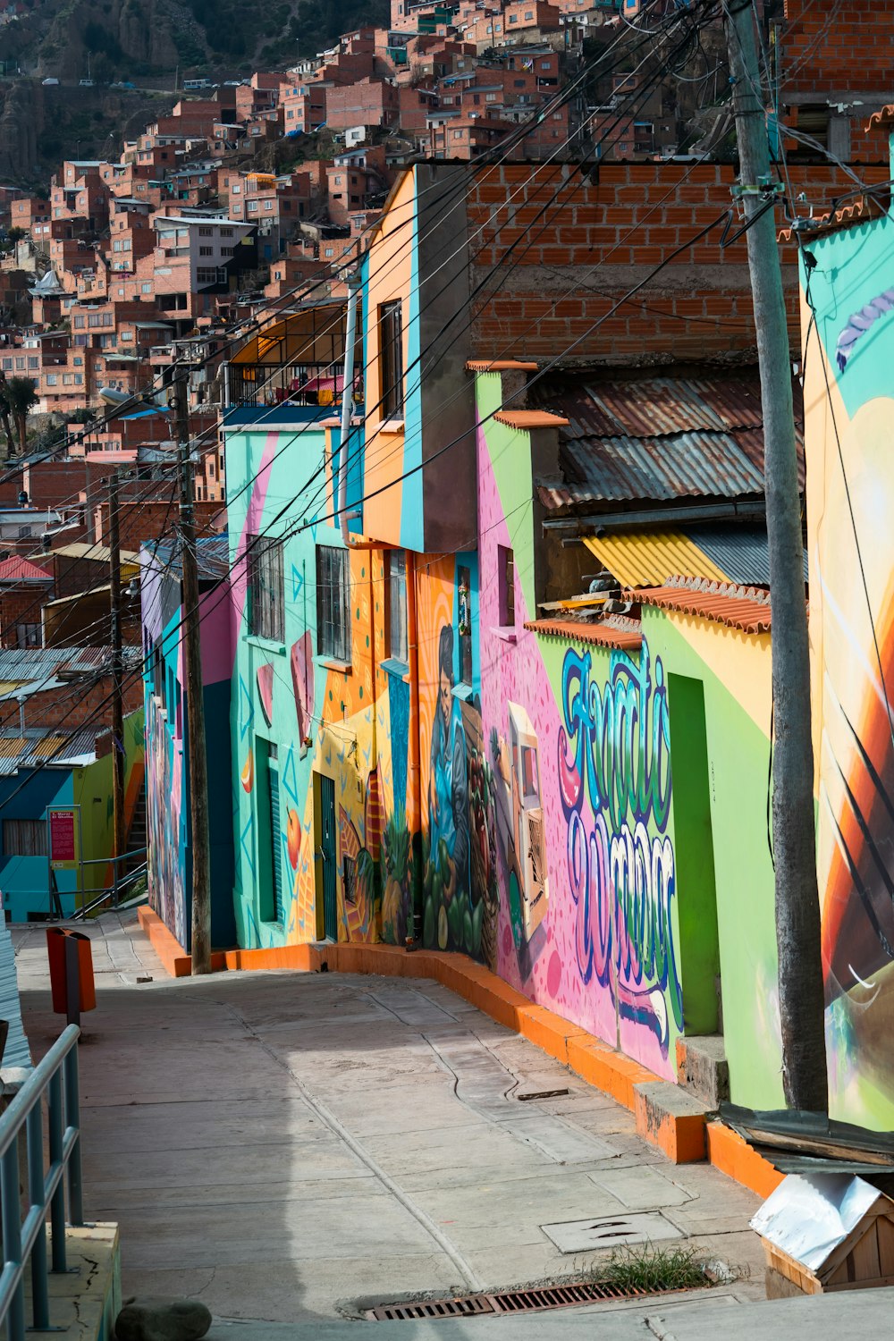 a city street with a lot of graffiti on the buildings