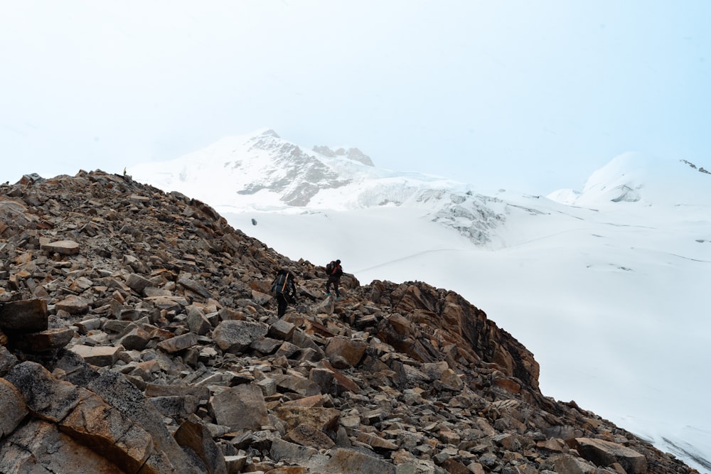 a group of people hiking up a rocky mountain