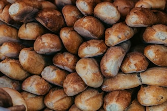 a pile of bread rolls sitting next to each other