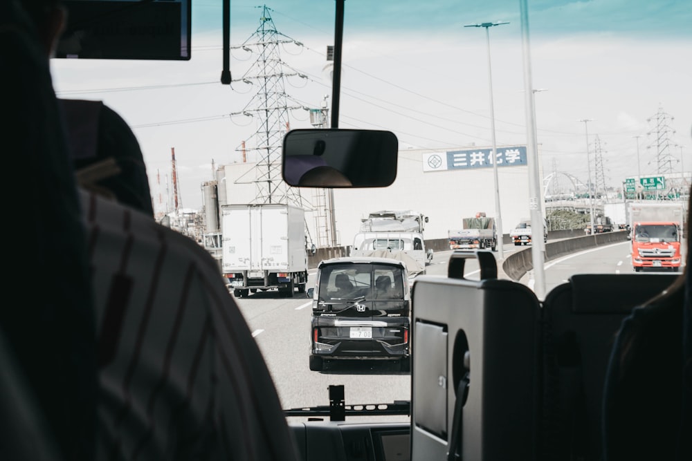 a truck driving down a highway next to a tall building