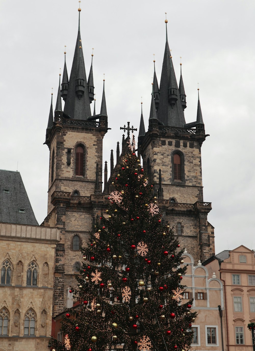 a large christmas tree in front of a church