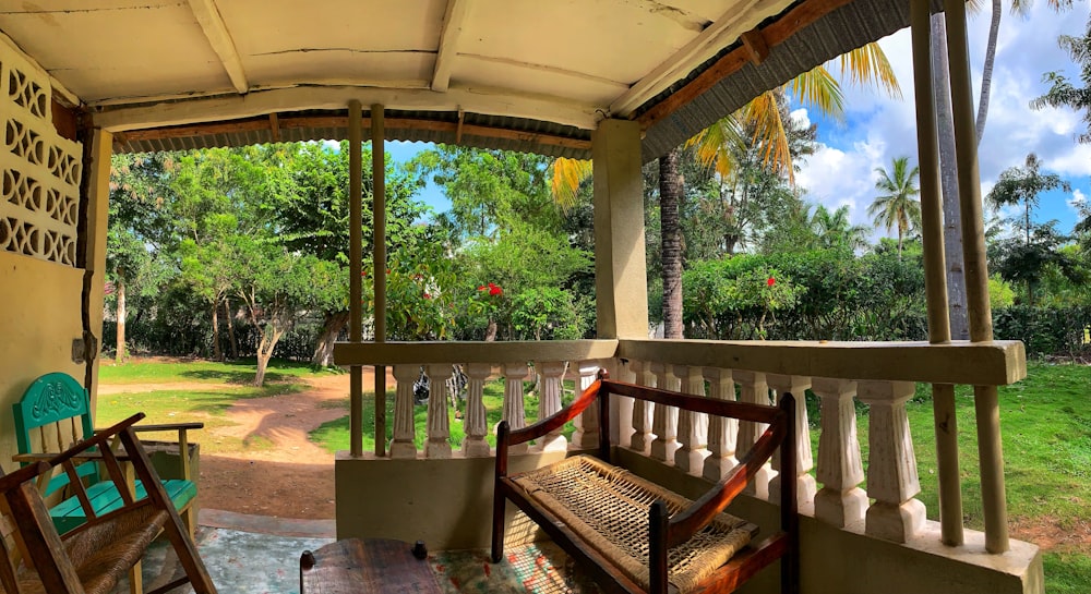 a wooden bench sitting on top of a porch