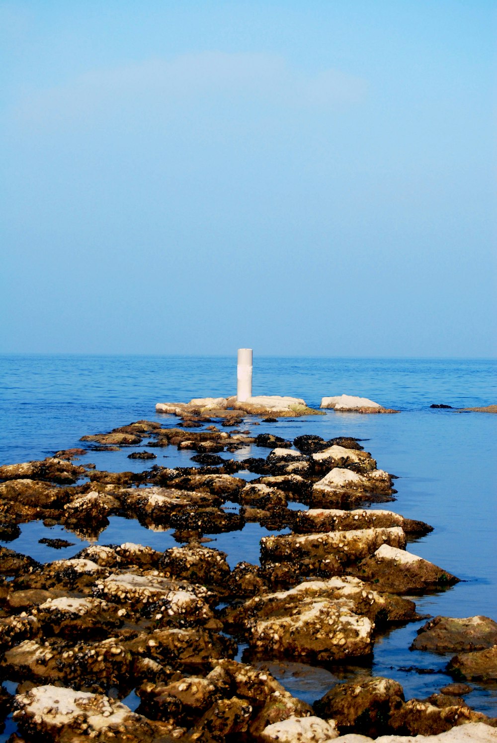 a lighthouse on the edge of a body of water