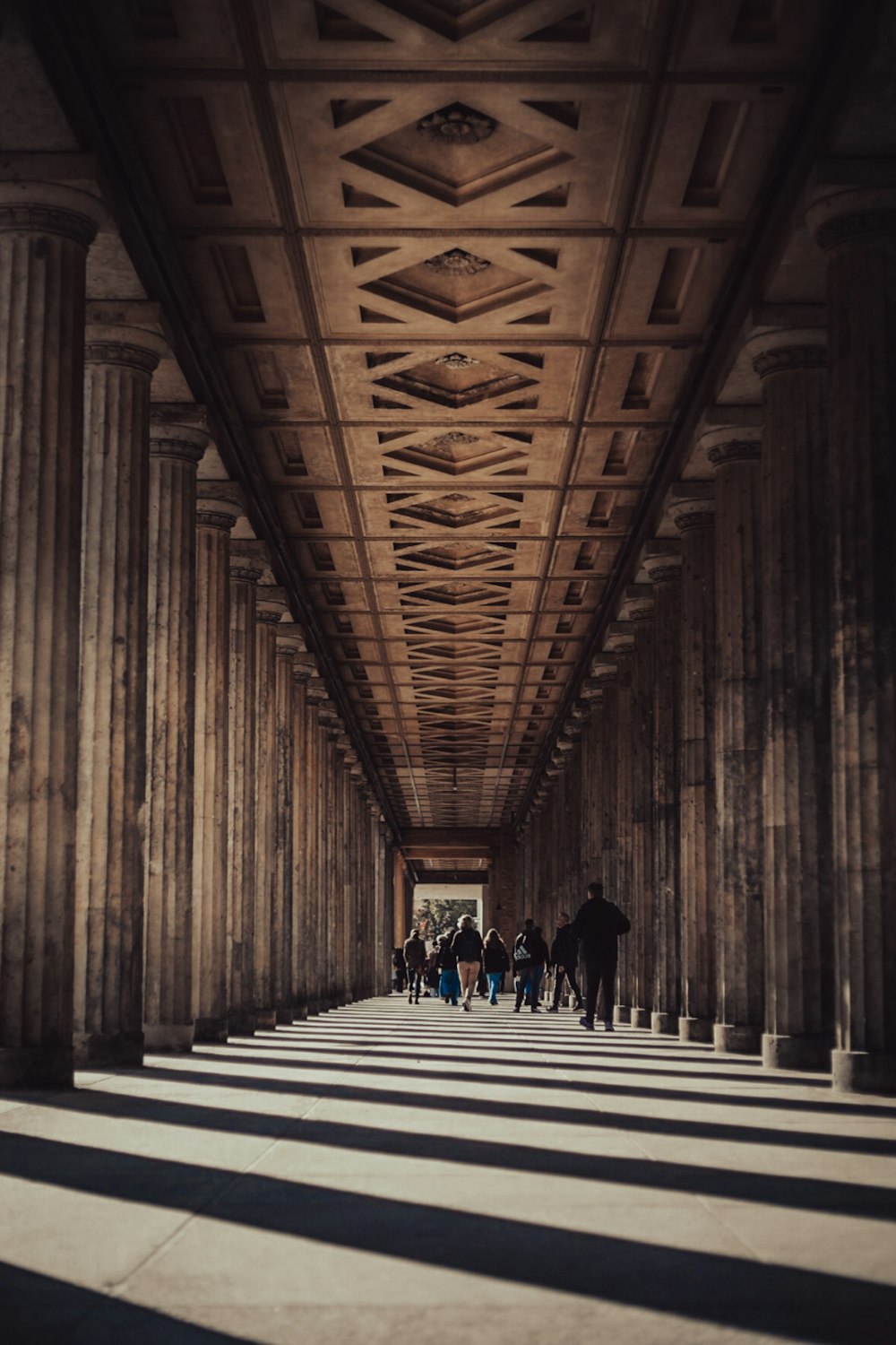 a group of people walking down a long hallway