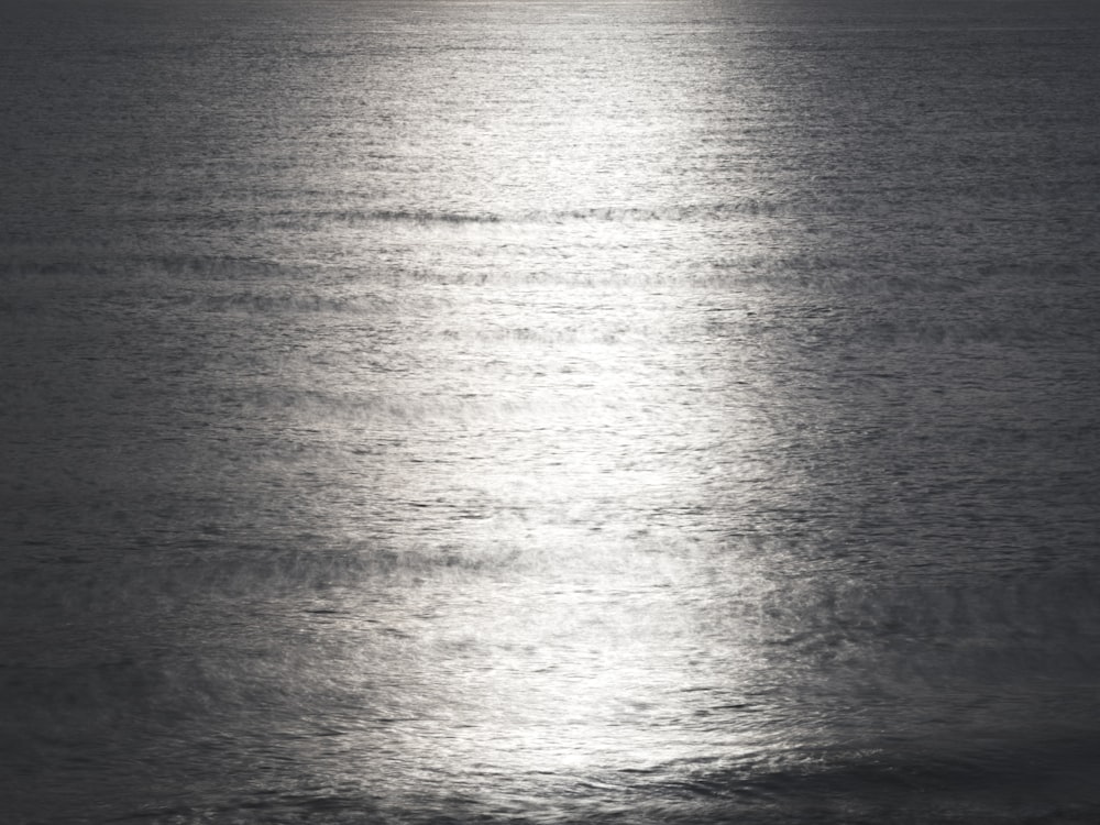 a large body of water with a boat in the distance